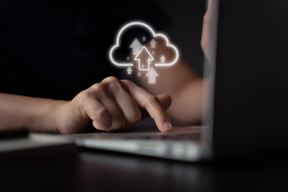 2 n-using-laptop-upload-with-cloud-icon-hologram-effect.jpg