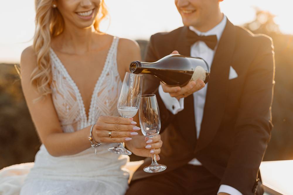 5 -rooftop-against-backdrop-city-man-carefully-pours-champagne-wine-into-glasses.jpg